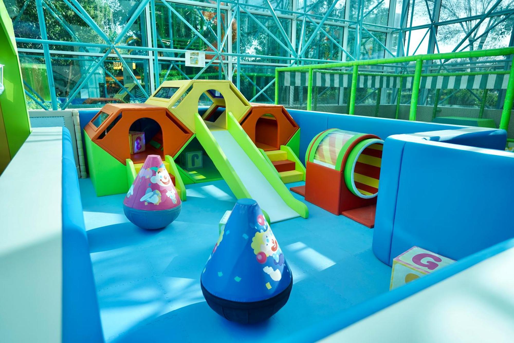 Grand Hyatt Dubai Hotel Exterior photo The photo shows a colorful indoor play area designed for young children. It features various play structures, including a small slide, climbing structures shaped like hexagons, and a tunnel. There are also large, soft, rounded toys in vibrant colors,